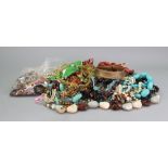 A large collection of costume jewellery necklaces, ropes of beads, brooches,