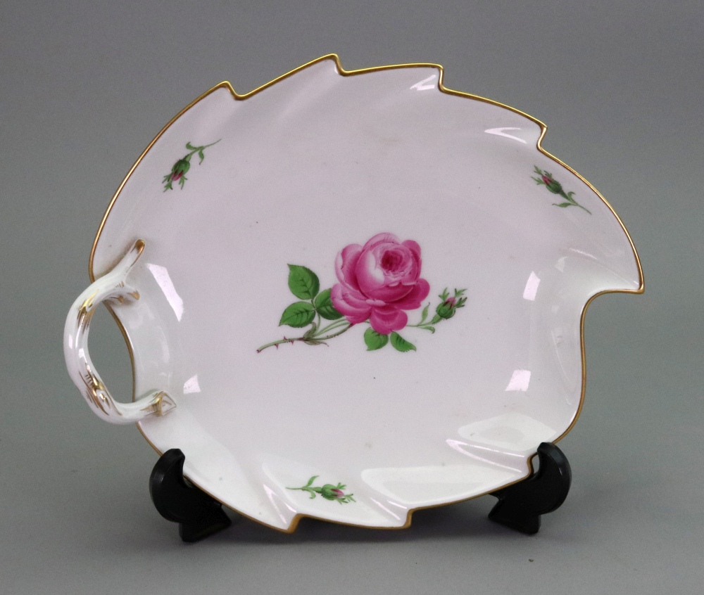 A Meissen leafy shape dish, 20th century, painted with pink roses and gilded, 22cm wide.