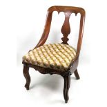 A walnut side chair, circa 1840, with a curved open back and baluster shaped solid splat,