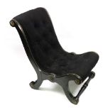 A late Regency ebonised gilt metal mounted slipper chair, button down upholstered in black.