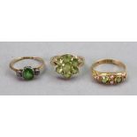 A gold, green gemset and diamond ring, the demantoid garnet set between two old cut diamonds,
