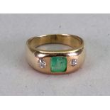 A gold, emerald and diamond ring, the emerald flush set between two old cut diamonds, ring size S,