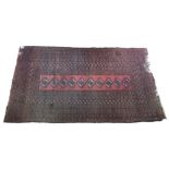 An Afgan rug, the rust field with ten quartered guls to the narrow rectangular panel, 229cm x 129cm,