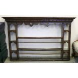 A George III oak Delft rack, with a moulded and arched dentil cornice,