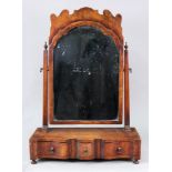A reproduction early 18th century style walnut swing toilet mirror, with shaped arched top plate,