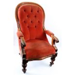 An early Victorian moulded walnut frame armchair, with button down upholstered back,