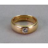 An 18ct gold and diamond single stone ring, the cushion cut diamond in star gypsy setting,