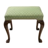 A reproduction George I style walnut dressing stool, the stuff over rectangular seat, on shell,