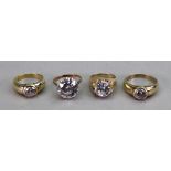 Two 9ct gold and cubic zirconia claw set rings and two rubover set cubic zirconia rings, 26.