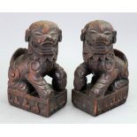 A pair of Chinese wood bookends, 20th century, each carved as a Buddhist lion,