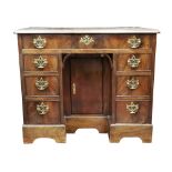 A George III mahogany kneehole desk, the moulded rectangular top above a long freize drawer,