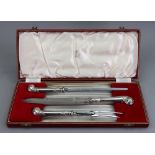 A cased three piece carving knife set, Garrard & Co, in George II style,