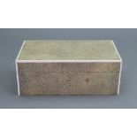 An Art Deco rectangular shagreen cigarette box, with hinged cover and ivorine bandings, 18 x 10 x 6.