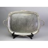 A George IV style silver two handled tea tray, William Hutton & Sons, London 1908, with shell,