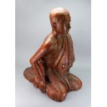 A large Burmese painted wood figure of a disciple, late 19th/20th century, carved kneeling,