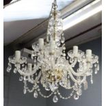 A modern cut glass nine light chandelier, with scrolled branches, arranged in two rows,