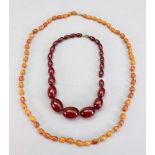 A row of amber oval beads, the beads on a base metal clasp, approximately 37cm long overall,