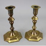 A pair of George II style silver shape cast brass candlesticks,