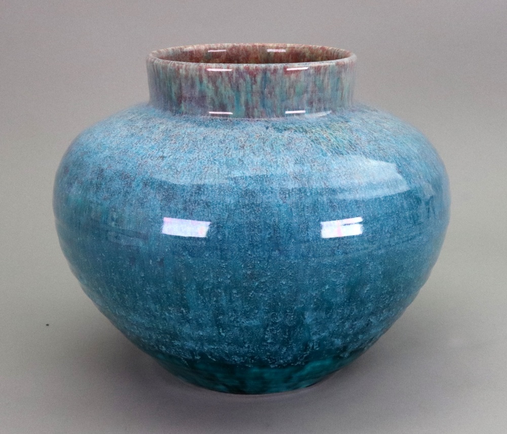 An Art Pottery oviform vase, the ribbed sides covered in a mottled blue/green running glaze, 18.