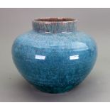 An Art Pottery oviform vase, the ribbed sides covered in a mottled blue/green running glaze, 18.