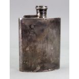 An engine turned silver hip flask, Birmingham 1959, curved to fit the pocket,