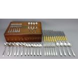 An oak cased part canteen of electroplate Old English pattern flatware and cutlery, Walker & Hall,