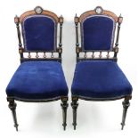 A pair of Aestethic period ebonised walnut boxwood strung and inlaid salon chairs,