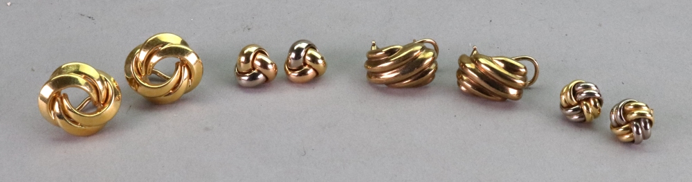 A pair of gold interwoven knot design earrings, the backs with posts and clip fittings, stamped 750,
