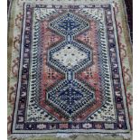 A North West Persian rug, with three joined lozenge medallions, 140 x 98cm, and another rug,