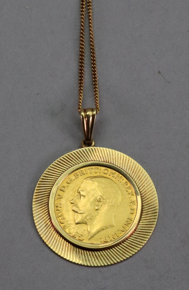 George V sovereign 1912, mounted in yellow metal and with 14ct gold chain, stamped '585', 9.5 gross.