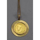 George V sovereign 1912, mounted in yellow metal and with 14ct gold chain, stamped '585', 9.5 gross.