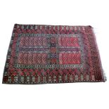 An Afgan rug, the rust field with four rectangular panels, 200cm x 140cm.