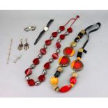 A bakelite multi-coloured bead necklace, probably 1960's with three circular mounted rosewood discs,