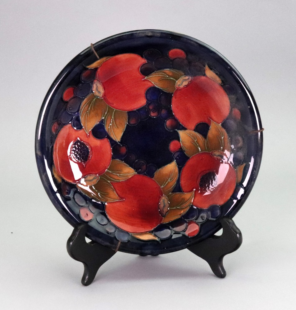 A Moorcroft Pomegranate pattern circular dish, 21.5cm diameter.