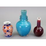 A miniature Chinese flambé bottle vase, 20th century, covered in a deep red glaze,