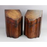 A pair of George III mahogany boxwood banded knife boxes, of serpentine outline,