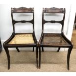 A pair of Regency rosewood and faux rosewood dining chairs, with scroll,