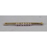 A gold and diamond set seven stone bar brooch,