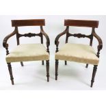 A pair of George III mahogany open arm elbow chairs, with reeded frames,
