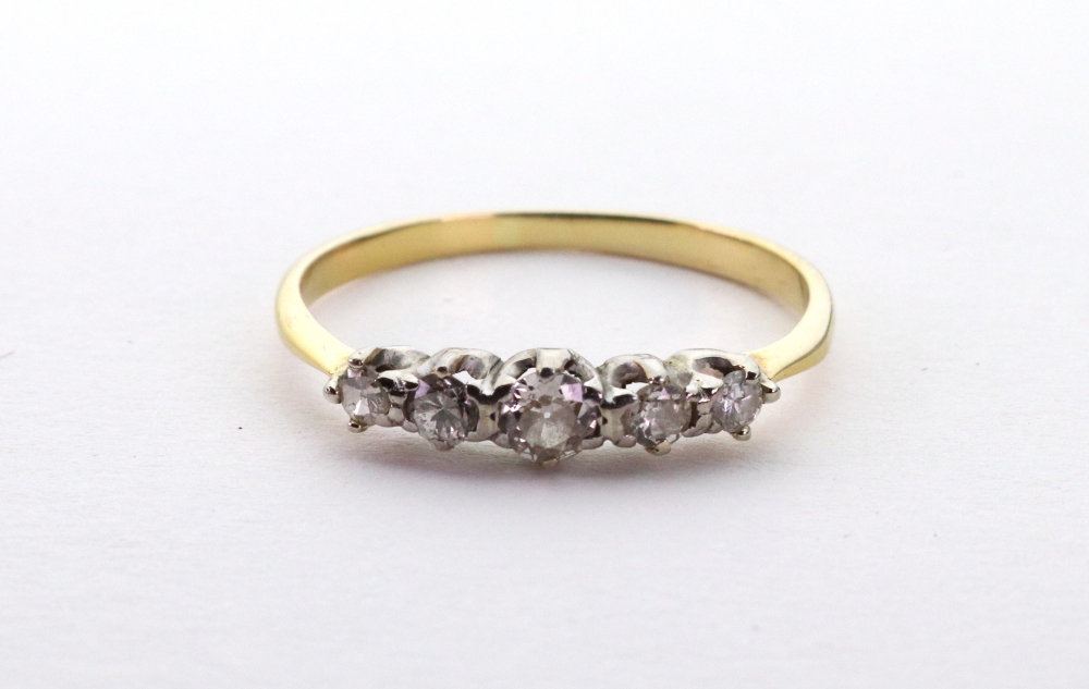 A graduated five-stone brilliant-cut diamond ring, claw-set in white on a yellow metal shank,