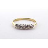 A graduated five-stone brilliant-cut diamond ring, claw-set in white on a yellow metal shank,