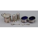 A pair of oval silver salt cellars and pair of matching pepperettes, Birmingham 1911 & 1912,