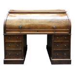 A Victorian walnut cylinder front kneehole desk, with gallery back, satinwood faced fitted interior,