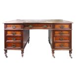 An Edwardian mahogany and walnut kneehole desk, with inset rectangular top,