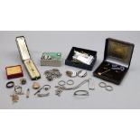 A collection of jewellery, comprising; eight rings, a diamond stick pin, in a box,