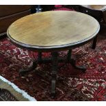 A Victorian mahogany loo table, circa 1880, the hinged oval top on four turned and fluted pillars,