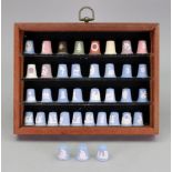 Thimbles in display case: Wedgwood nursery rhymes, Christmas and Royal Wedding and Royal Birth,