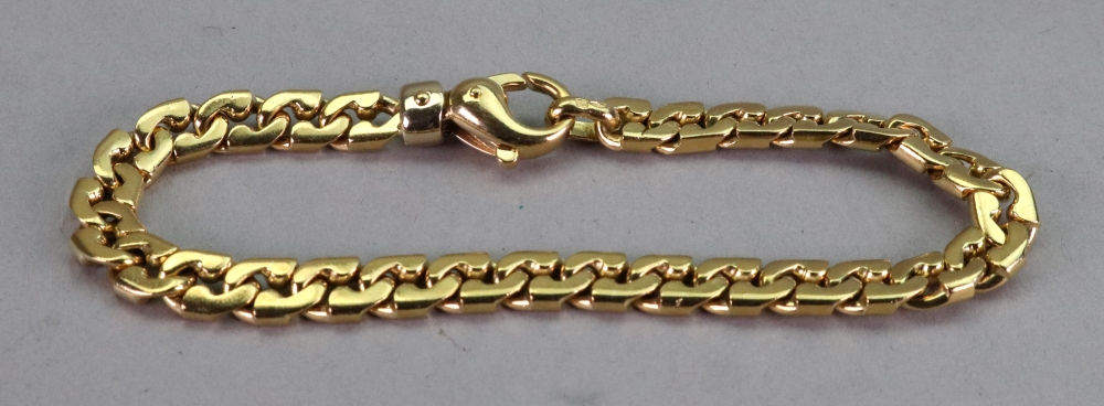A gold flat curb link bracelet, with oval lobster clasp, detailed 750, length approximately 20.