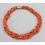 A coral necklace, designed as multi-row plait, with engine turned base metal snap clasp,