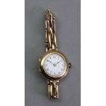 A lady's 15ct gold manual wind wristwatch, the white enamel dial with Arabic numerals,